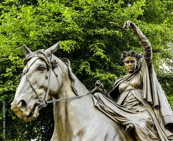 Fototapeta Partial view of the bronze statue of Banbury's Fyne Lady, astride a horse. From the nursery rhyme. Set in South Bar, Banbury. Background of tree, looking upwards. Oxfordshire. England.