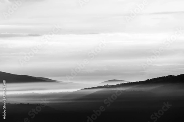 Fototapeta A view of Umbria valley with hills and mist