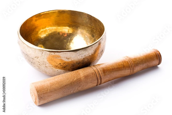 Fototapeta Closeup of a singing bowl and its mallet on a white backround