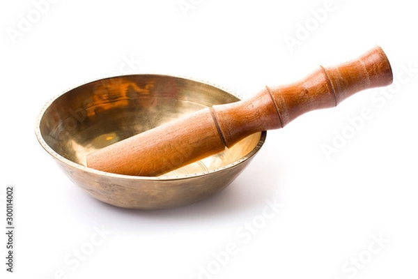 Fototapeta Closeup of a singing bowl and its mallet on a white backround