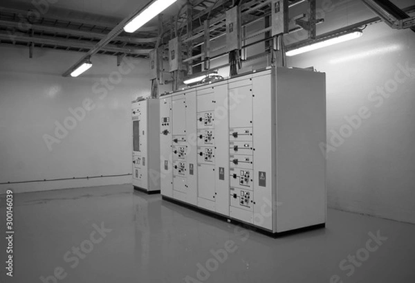 Fototapeta Electrical control cabinet and circuit breakers are usually securely locked in the control rooms of new commercial buildings.Black & White