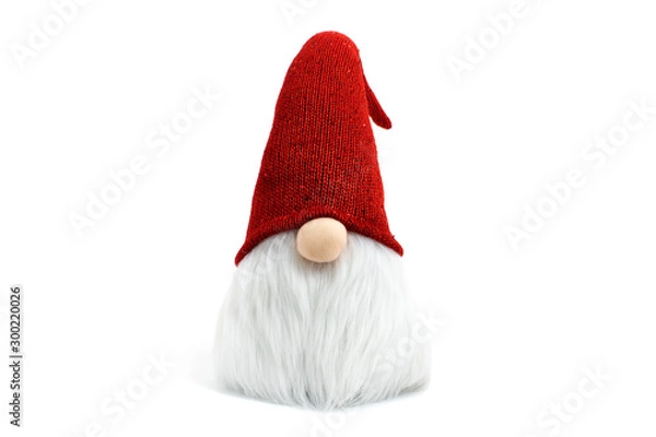 Obraz Gnome a Christmas elf wearing big red with glitters hat and standing on white background