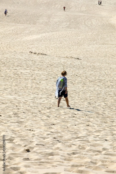 Fototapeta Woman on the Dune of Pilat, the tallest sand dune in Europe. La Teste-de-Buch, Arcachon Bay, Aquitaine, France