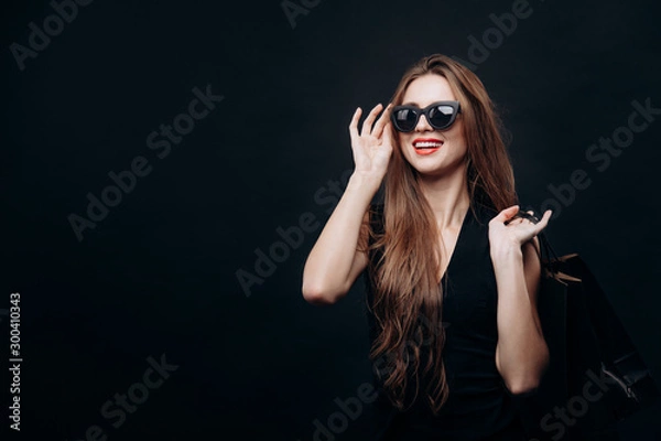 Obraz Contented Customer Adjusting Sunglasses Looking Forward for More Shopping