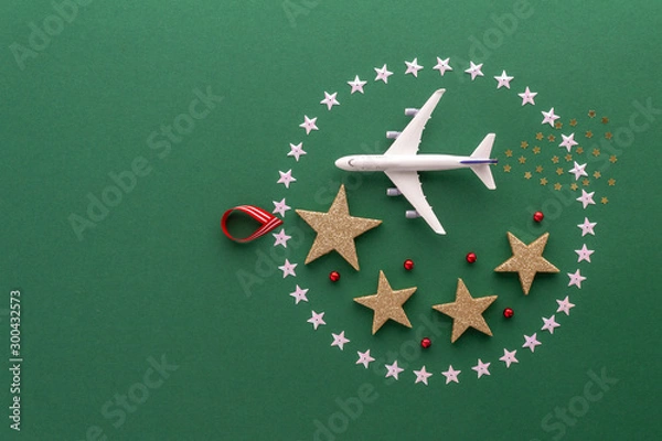 Fototapeta Christmas composition. Christmas ball stars airplane top view background with copy space for your text. Flat lay.