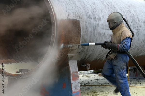Fototapeta engineer sandblasting a steel casing
