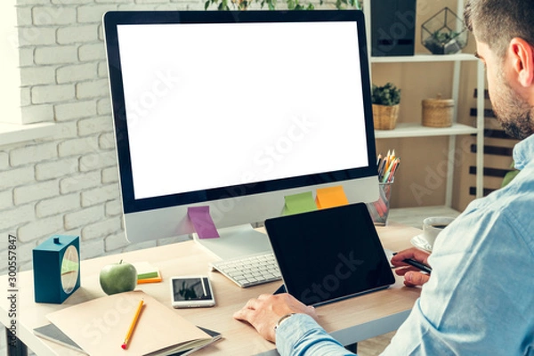 Fototapeta Businessman looking at computer monitor during working day in office