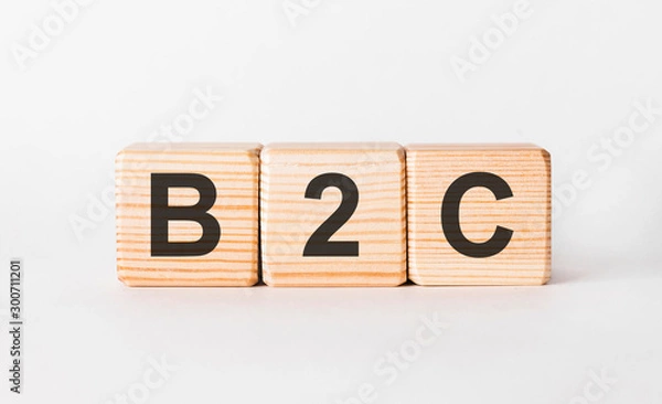 Fototapeta B2C letters of wooden blocks in pillar form on white background, copy space