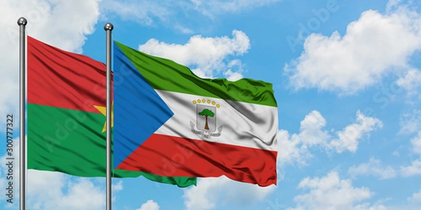 Obraz Burkina Faso and Equatorial Guinea flag waving in the wind against white cloudy blue sky together. Diplomacy concept, international relations.