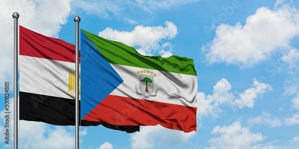 Obraz Egypt and Equatorial Guinea flag waving in the wind against white cloudy blue sky together. Diplomacy concept, international relations.