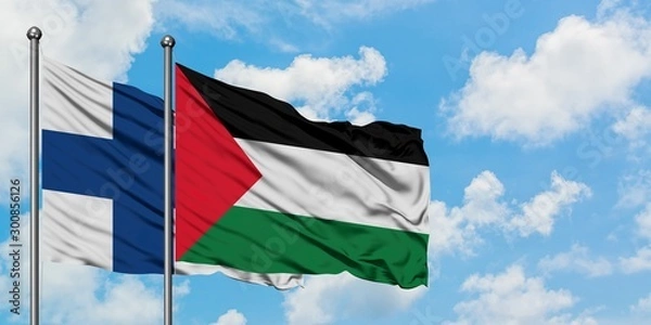 Fototapeta Finland and Palestine flag waving in the wind against white cloudy blue sky together. Diplomacy concept, international relations.