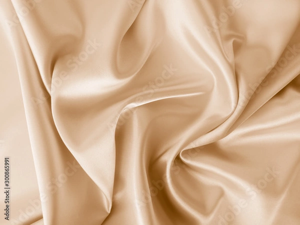 Fototapeta Beautiful smooth elegant wavy beige / light brown satin silk luxury cloth fabric texture, abstract background design. Copy space.