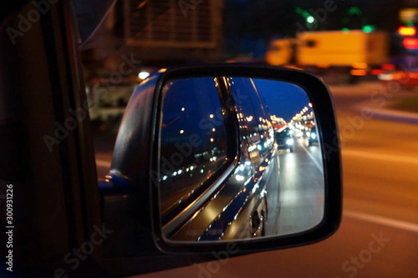 Fototapeta reflection in the side mirror of car traffic in the evening