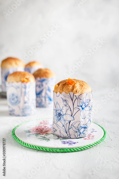 Fototapeta Homemade Easter cakes in paper wrapper. Light background