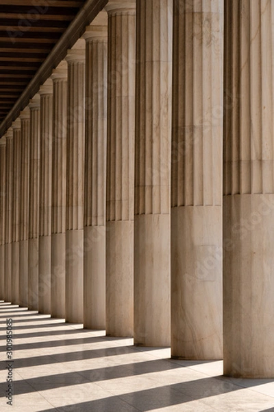 Fototapeta Row of ancient Greek columns in Athens. Architectural abstract.