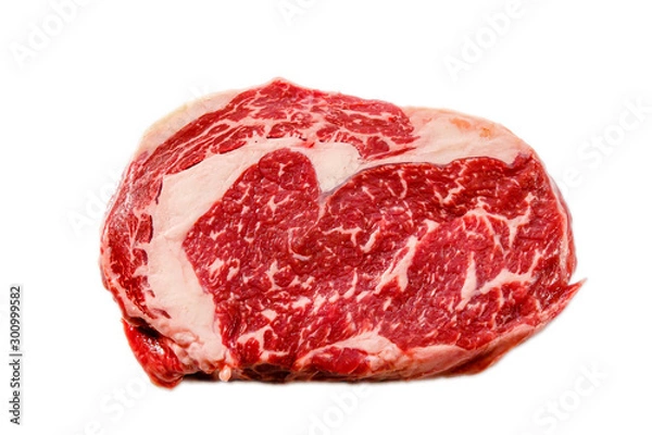 Fototapeta A rib eye steak of marbled grain-fed beef lies on a white background. Isolated.