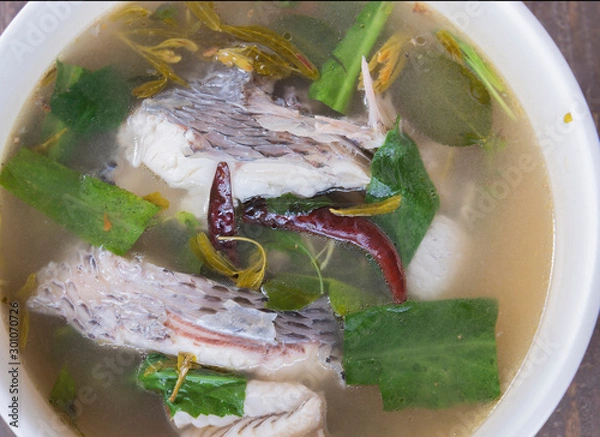 Fototapeta hot and sour soup tilapia fish in white plate . selective focus.
