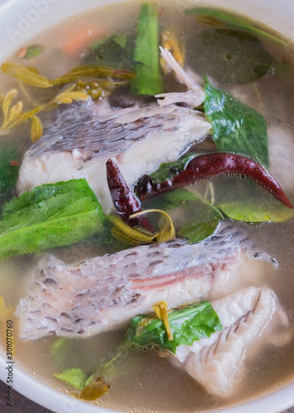 Fototapeta hot and sour soup tilapia fish in white plate . selective focus.