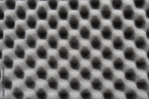 Fototapeta Dark artificial foam, acoustic foam insulation texture on background.