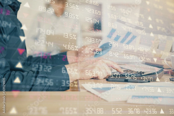 Obraz Double exposure of graph with man typing on computer in office on background. Concept of hard work. Closeup.