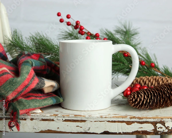 Fototapeta Blank white coffee mug mockup on shabby chic white wood background with winter and Christmas accessories