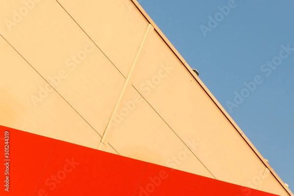Fototapeta Geometric colored building facade elements with planes, lines and corners with light flare and reflections for an abstract background and texture of white, blue, gray colors. Place for text
