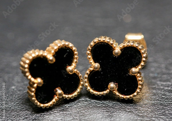 Obraz Small black clover earrings on white background. - Image