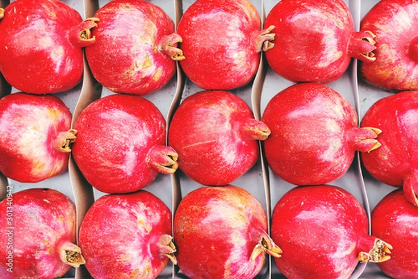 Fototapeta pomegranates are on the counter in a vegetable store