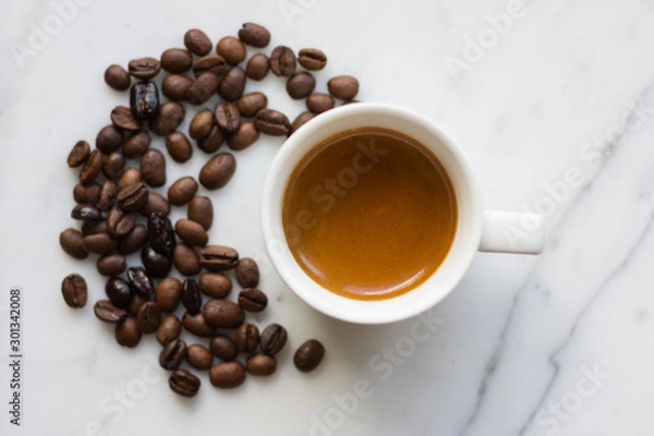 Obraz Small espresso cup with coffee beans isolated on marble background