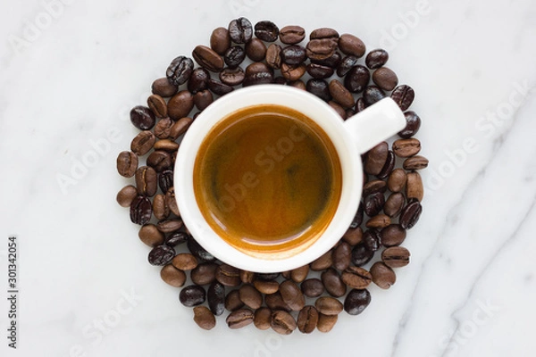 Obraz Small espresso cup with coffee beans isolated on marble background