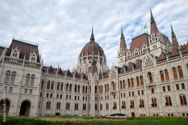 Obraz View of historical building of Hungarian Parliament in Budapest, Hungary, Europe on background of bright blue cloudy sky