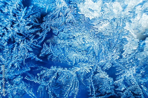 Fototapeta Beautiful frozen patterns on glass, macro photo. The concept of winter, the beauty of nature, frost, cold. Abstract background image.