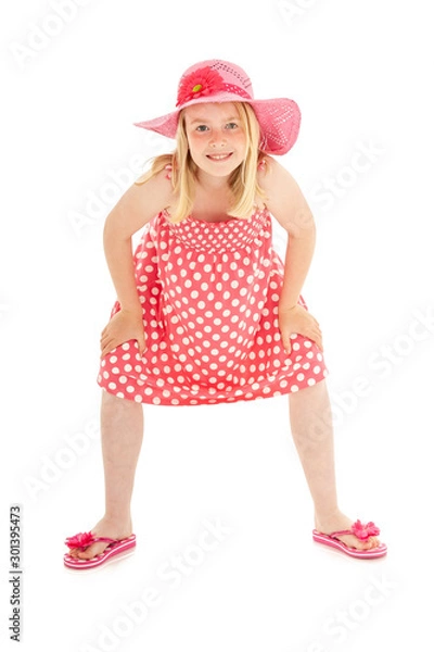 Obraz Full length shot of beautiful young blonde girl in big pink floppy hat, a polka dot dress and flip flops. Isolated on white studio background