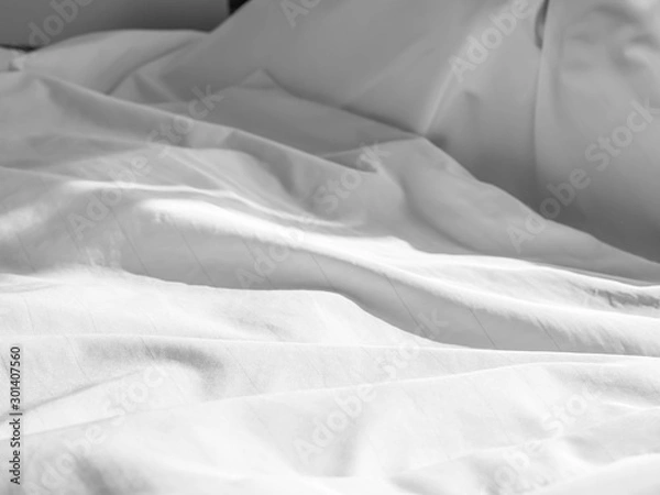 Obraz Abstract wrinkles white dust mites bedding cover, fabric or textile texture, pattern and background. Crumpled blanket on the bed in the bedroom.