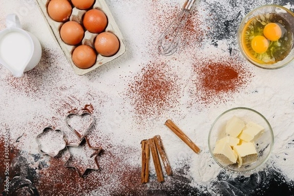 Fototapeta Cooking And Baking Ingredients Utensils On White Concrete Background. Kitchen Food Frame. Eggs Sugar Milk Whisker Rolling Pin And Measuring Spoons With Spices