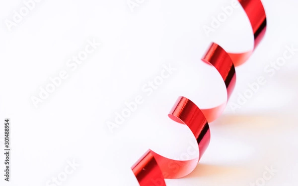 Obraz Red tinsel on white background.