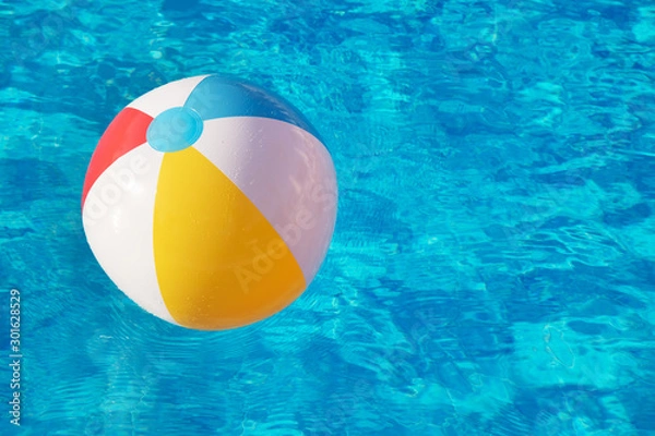 Obraz Colorful inflatable ball floating in swimming pool