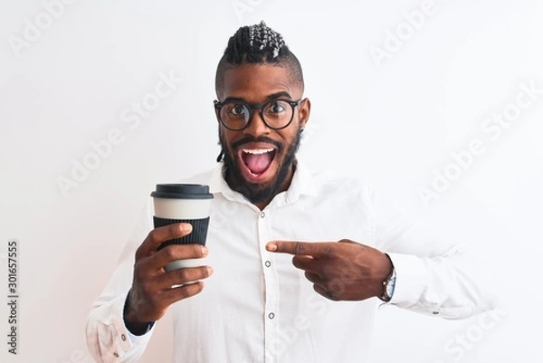 Fototapeta African american businessman with braids drinking coffee over isolated white background very happy pointing with hand and finger