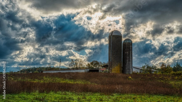 Fototapeta Two silos in a field on a farm on a stormy day