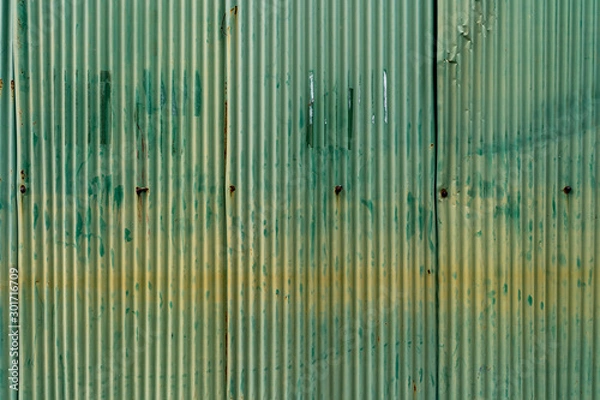 Fototapeta Background of old green zinc and rust. Rust on old green zinc background wall. Rusty corrugated metal wall. Old green zinc wall surface Fence house zinc background.