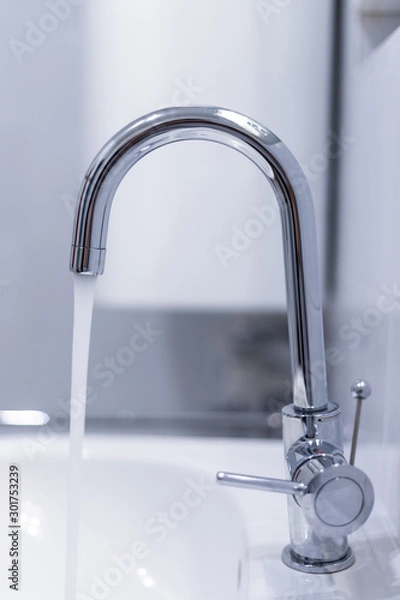 Fototapeta Saving water: Close up of spigot with clear, flowing water