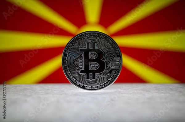 Fototapeta Physical silver version of Bitcoin (BTC) and Macedonia Flag on the background. Conceptual image for investors in cryptocurrency and Blockchain Technology.