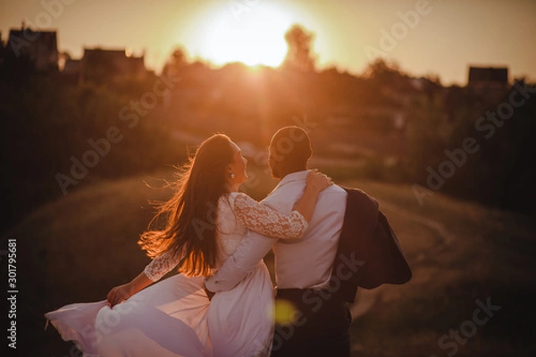 Obraz Lovely mixed couple is watching the sunset