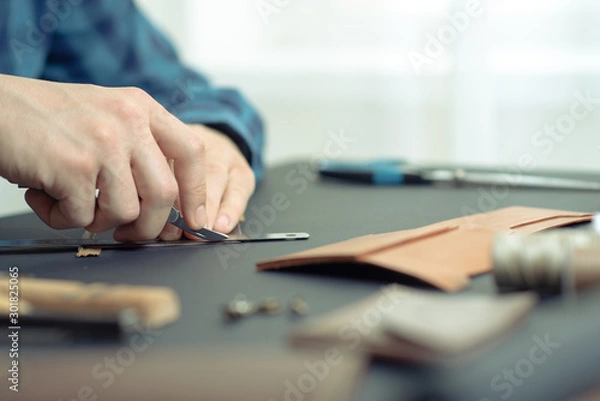 Fototapeta leather wallets on a black background with space for an inscription. Leather craft concept.