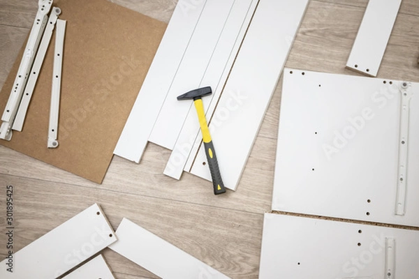 Obraz Furniture assembly parts and tools for self assembly furniture, on the floor. instructions for furniture assembling with tools