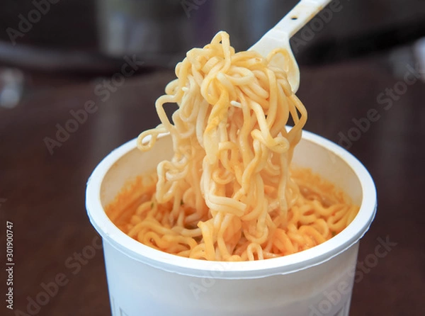 Obraz Fastfood spice instant noodles. Cooked instant noodles soup in the white plastic cup.