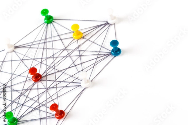 Fototapeta Network with colorful pins and string,  linked together with string on a white background suggesting a network of connections.