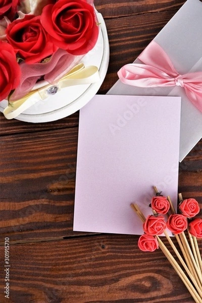 Obraz Gift box with flowers on wooden background, preparation for the holiday concept. Top view and copy area for text.