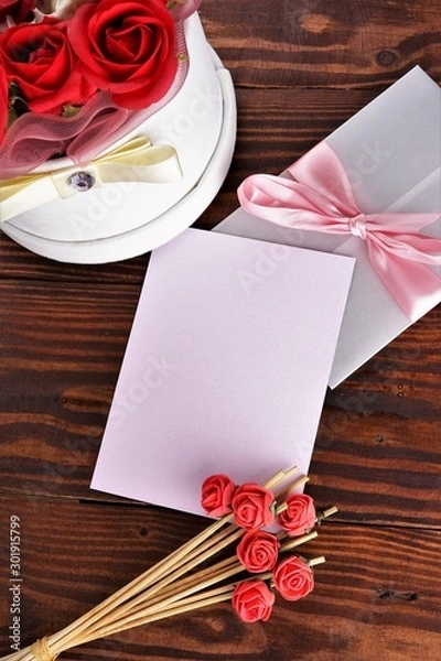 Obraz Gift box with flowers on wooden background, preparation for the holiday concept. Top view and copy area for text.
