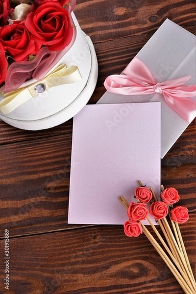 Obraz Gift box with flowers on wooden background, preparation for the holiday concept. Top view and copy area for text.